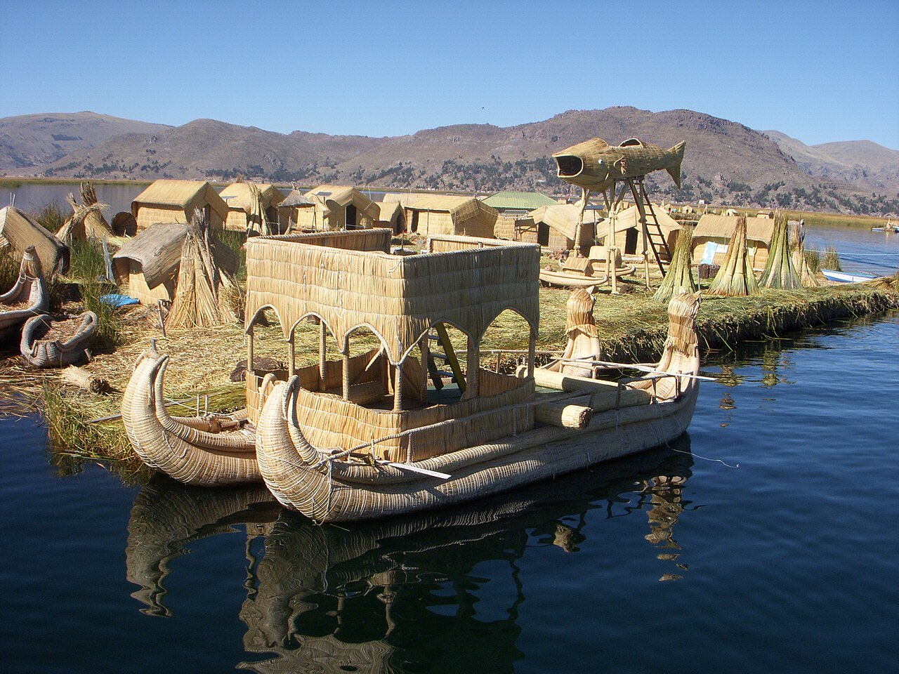 Reed boats moored beside reed-built houses on a floating island on Lake Titicaca
