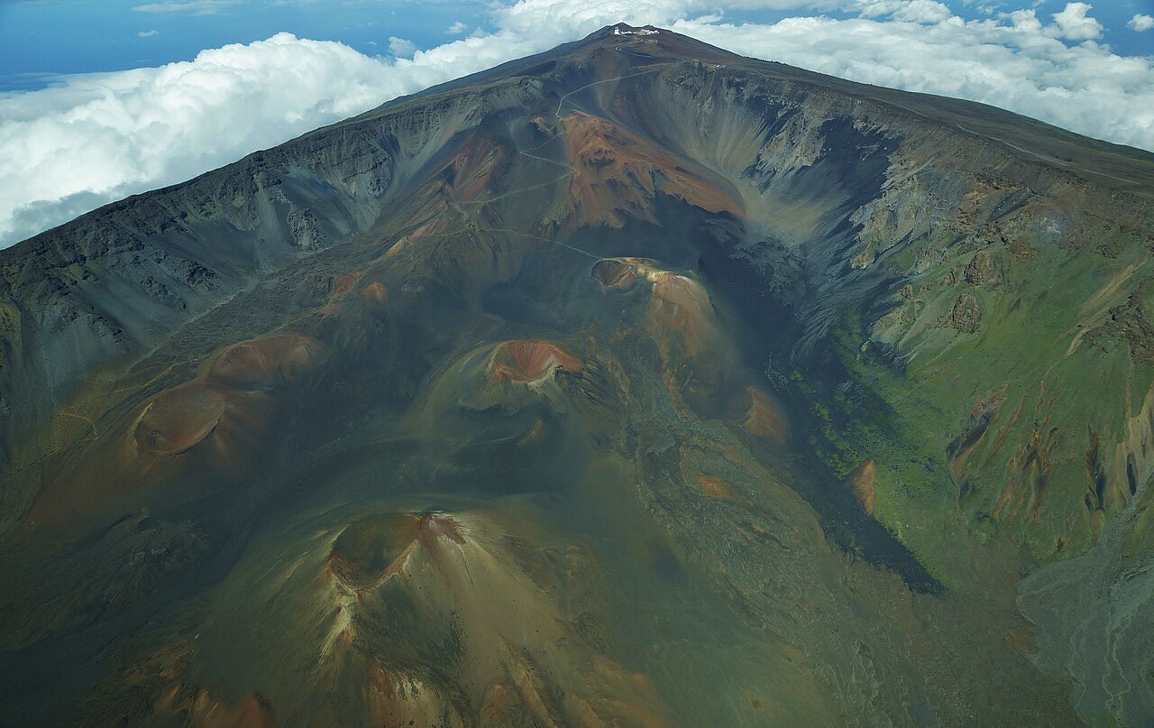 Aerial view of the Haleakala summit depression on Maui with red and black cinder cones on the crater floor
